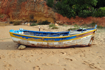 Close Up of Old Wooden Fishing Boat on Sandy Beach 
