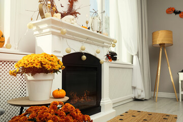Modern room with fireplace decorated for Halloween. Festive interior