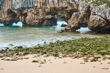 Picturesque rocky coastline in Asturias, Playa de las cuevas. Spain © h368k742