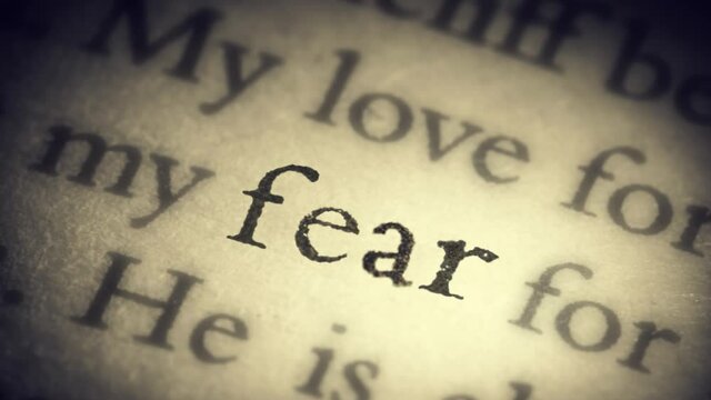 The word fear on an old page in the book is separated from the general text and zooms into the camera. Creative 3D 4k slow motion video animation.