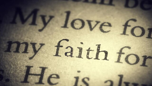 The word faith on an old page in the book is separated from the general text and zooms into the camera. Creative 3D 4k slow motion video animation.