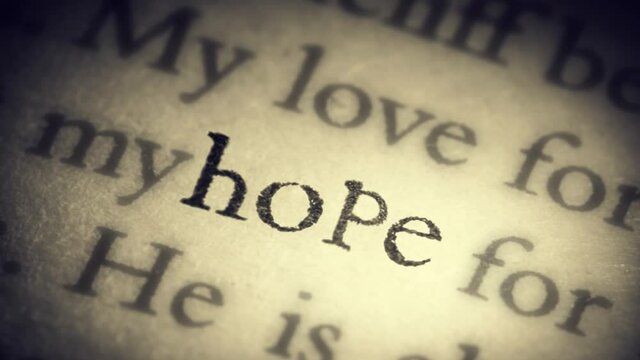 The word Hope on an old page in the book is separated from the general text and zooms into the camera. Creative 3D 4k slow motion video animation.