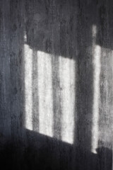 Vertical banner of Window shade silhouette on a gray concrete wall made of white day sunlight from the window