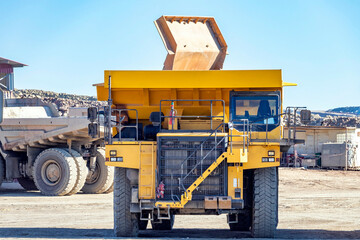 Big mining heavy dump trucks in open mining pit