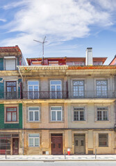 Rua do Rossario or Rossario street. Fragment of the facade of typical building with balconies, decorated with azulejo tiles. Porto, Portugal