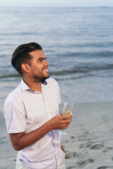 Latin Man drinking champagne outdoors