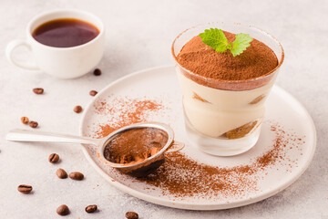 Traditional Italian dessert tiramisu in a glass.