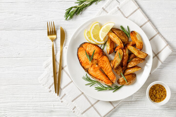 baked salmon steak and potatoes on a plate
