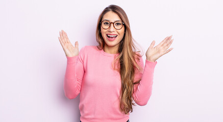 asian pretty woman feeling shocked and excited, laughing, amazed and happy because of an unexpected...