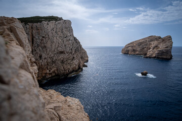 Fototapeta na wymiar Cliffs at Capo Caccia Sardinia Italy. Rocky high cliffs next to the ocean in Sardinia Italy. 