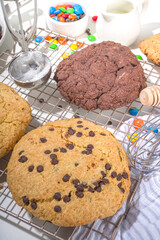 White and chocolate giant cookies. Very big cookies – chocolate, vanilla, chocolate chips, with ice cream ball. Trendy sweet baking.