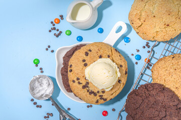 White and chocolate giant cookies. Very big cookies – chocolate, vanilla, chocolate chips, with ice cream ball. Trendy sweet baking.