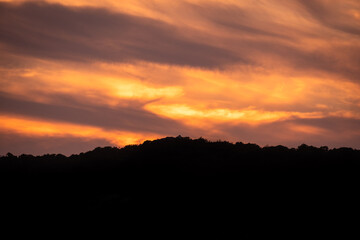Beautiful orange sunset.  Sunset in Sardinia. Red sky over hills. Aurora effect. 