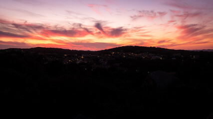 Fototapeta premium Beautiful orange sunset. Sunset in Sardinia. Red sky over hills. Aurora effect. 