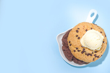 White and chocolate giant cookies. Very big cookies – chocolate, vanilla, chocolate chips, with ice cream ball. Trendy sweet baking.