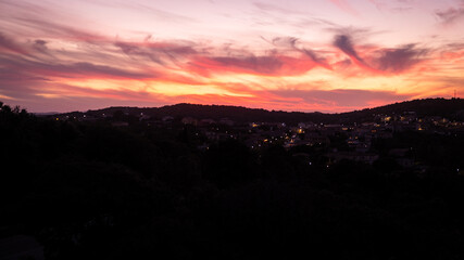 Beautiful orange sunset.  Sunset in Sardinia. Red sky over hills. Aurora effect. 