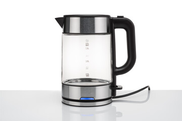 Glass, electric, modern transparent kettle on a white background. Close-up.