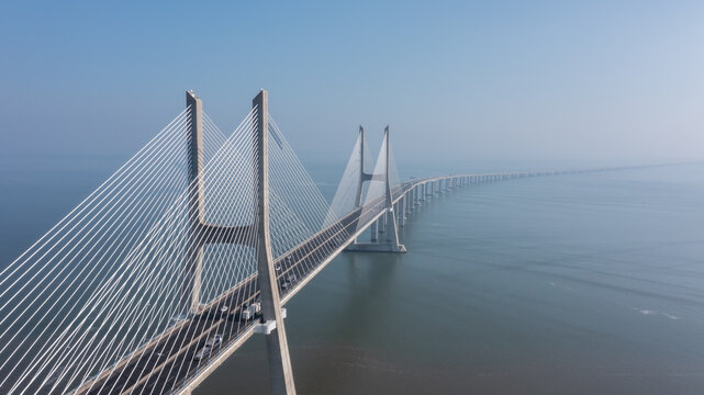 Fototapeta Aerial view of the most beautiful Portuguese bridge in Lisbon, Vasco da Gama. Morning foggy seascape.