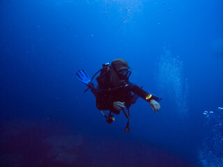 Fototapeta na wymiar Scuba diver in clear blue water. Diving in clear water. Sardinia Italy