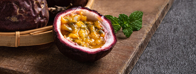 Delicious juicy passion fruit on gray table background.