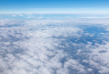 Fototapeta na wymiar Airplane point of view . Clouds and mountains view from above 