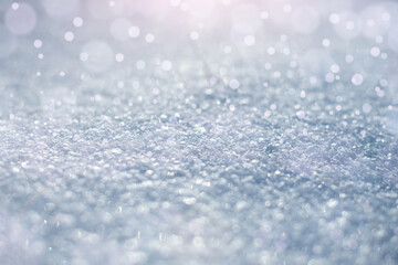 Macro texture of the snow surface with bokeh highlights, fabulous lighting effect and with a place for the inscription