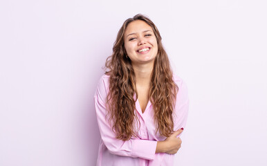 hispanic pretty woman laughing shyly and cheerfully, with a friendly and positive but insecure...