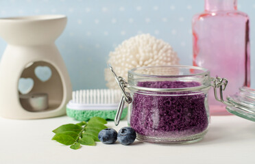 Obraz na płótnie Canvas Homemade blueberry face and body sugar scrub, bath salts, foot soak in a glass jar. DIY cosmetics for natural skin care. Copy space.