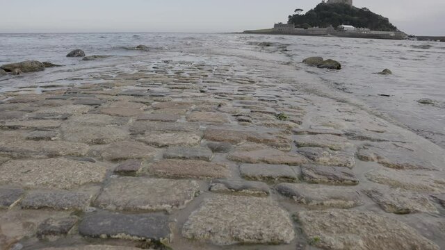 Part Submerged Cobbled Path to St Michael's Mount Low Shot - Slow Motion