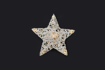 White star shaped night lamp on the on black background.