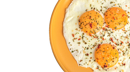 scrambled eggs with spices on an orange plate, top view