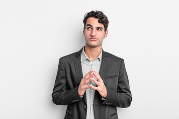 young businessman scheming and conspiring, thinking devious tricks and cheats, cunning and betraying