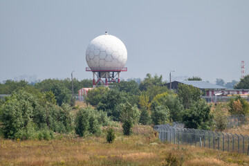 International airport white sphere radar tower. Special microwave tower radome in hexagon shapes in...