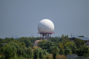 International airport white sphere radar tower. Special microwave tower radome in hexagon shapes in...