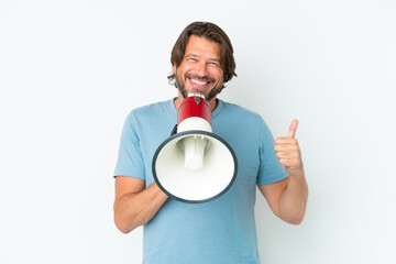 Senior dutch man isolated on white background shouting through a megaphone to announce something...