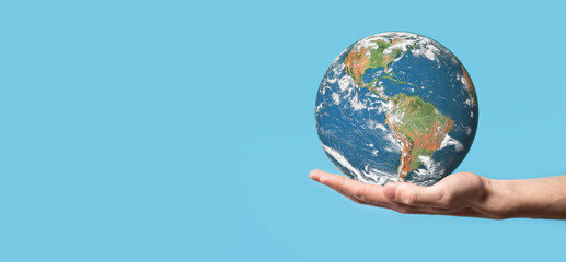 3D Earth planet globe in man, woman hand, hands on blue background. Environmental protection concept. Elements of this image furnished by NASA