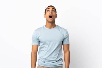 African American man over isolated white background looking up and with surprised expression