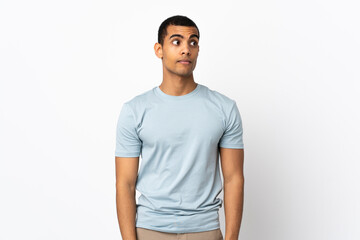 Fototapeta premium African American man over isolated white background making doubts gesture looking side