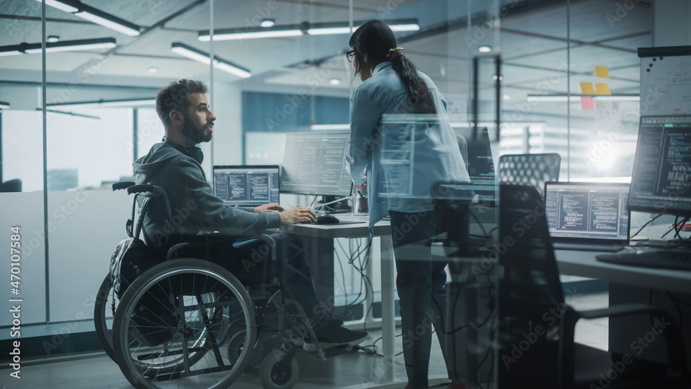 Poster Disability-Friendly Office: Happy IT Programmer with Disability in a Wheelchair Talks with Colleague while Working on Computer. Software Engineers Develop Innovative App, Program.