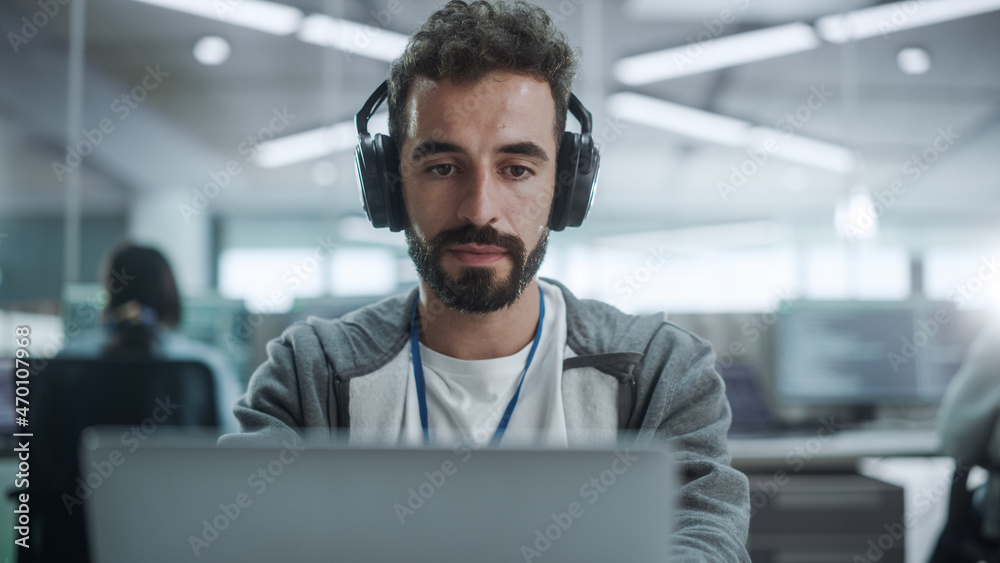 Poster Office: Portrait of Smiling IT Programmer Wearing Headphones Working on Desktop Computer. Male Website Developer, Software Engineer Developing App, Video Game. Listening to Podcast, Music. Close-up