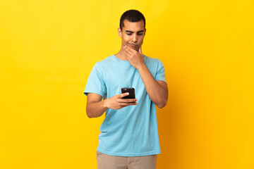 African American man over isolated background thinking and sending a message