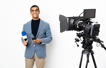 Reporter African American man holding a microphone and reporting news over isolated white background sending a message with the mobile