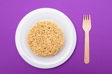Uncooked Instant Noodles on White Plate. Raw Pasta. Dry Asian Fast Food. Quick Lunch