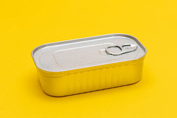 Unopened Tin Can with Blank Edge on Yellow Background. Canned Food. Aluminum Can for Safe and Long Term Storage of Food. Steel Sealed Food Storage Container