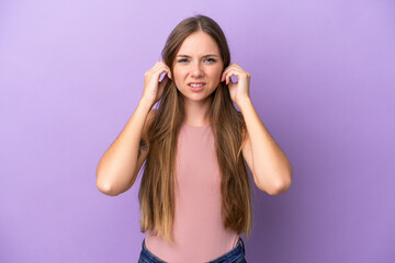 Fototapeta na wymiar Young Lithuanian woman isolated on purple background frustrated and covering ears