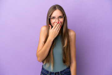 Young Lithuanian woman isolated on purple background happy and smiling covering mouth with hand