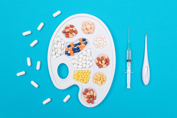 Global Pharmaceutical Industry and Medicinal Products - Different Colored Pills, Tablets and Capsules on White Art Palette with Thermometer Lying on Blue Background, Flat Lay