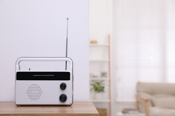 Stylish white radio on table indoors. Space for text