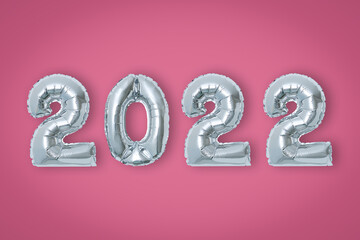 silver color Christmas 2022 balloons isolated on pink background