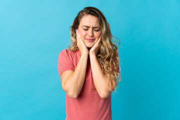 Young Brazilian woman isolated on blue background frustrated and covering ears